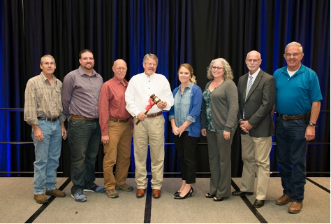 Photo 2: Joe B. Cooper (center, white shirt) stands surrounded by groundwater colleagues at the 2017 Texas Groundwater Summit as he is presented with a ceremonial gavel to commemorate his time as TAGD President
